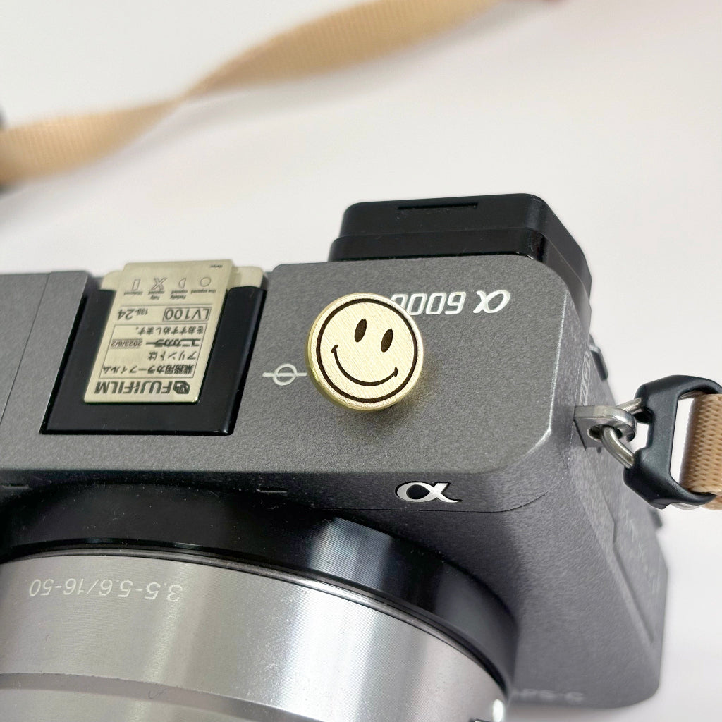 gold smile face camera shutter button