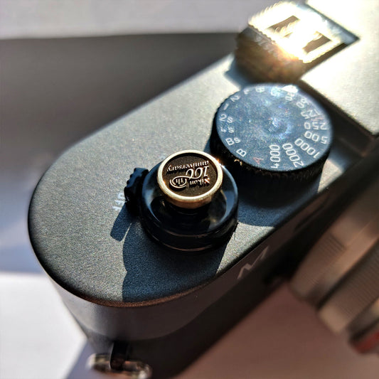 100th Nikon Camera shutter button gold right