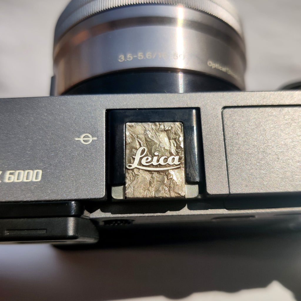 Silver crushstone leica camera hot shoe cover on camera