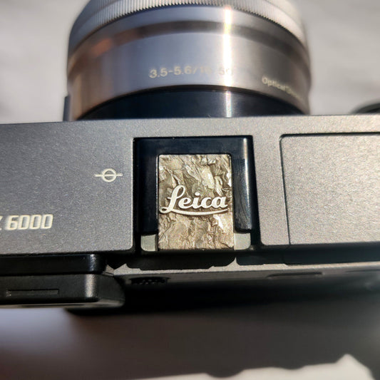Silver crushstone leica camera hot shoe cover on camera