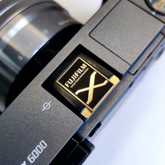 Fujifilm X logo gold hot shoe cover