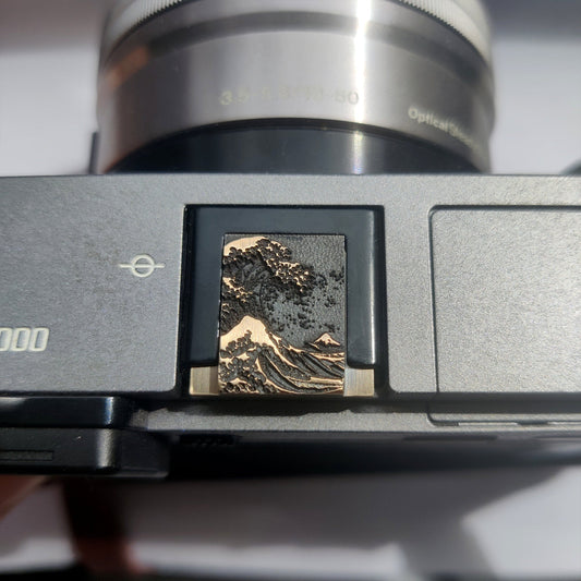sea wave hot shoe cover on camera 