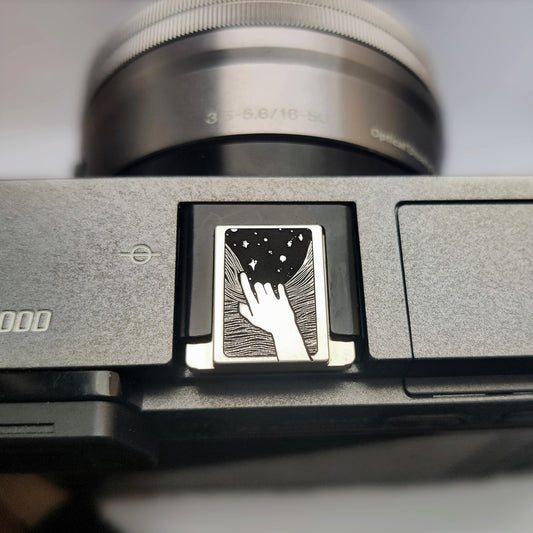 Reaching for the Stars  camera brass hot shoe cover front view